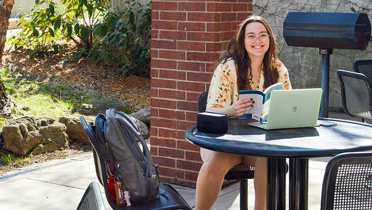 Student Studying in Scholars Courtyard