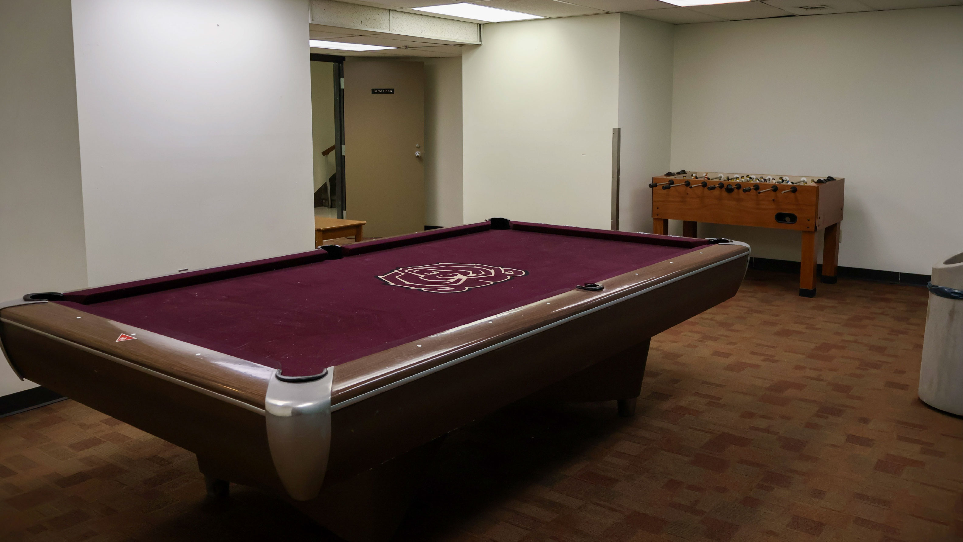 Room with pool table and football table