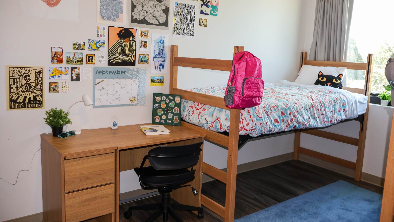 Heitz House  bedroom with lofted bed desk and chair and 2 drawer side table