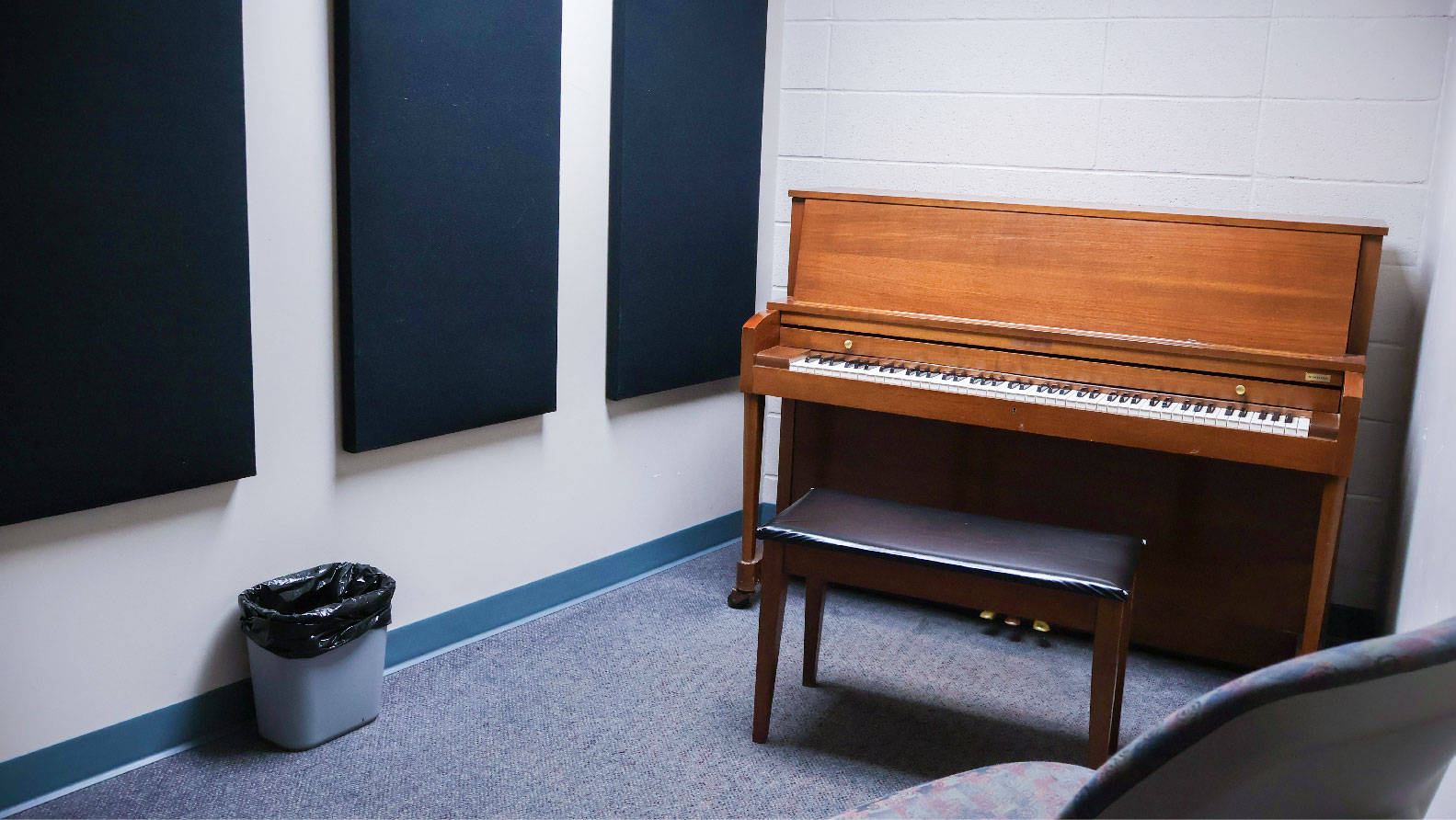 room with piano and chair