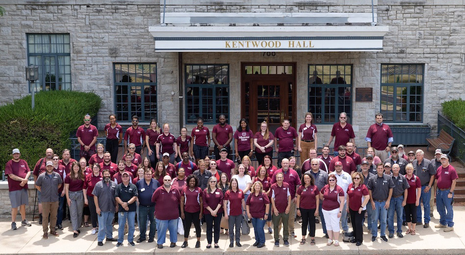 Residence Life Department team standing in front of Kentwood Hall