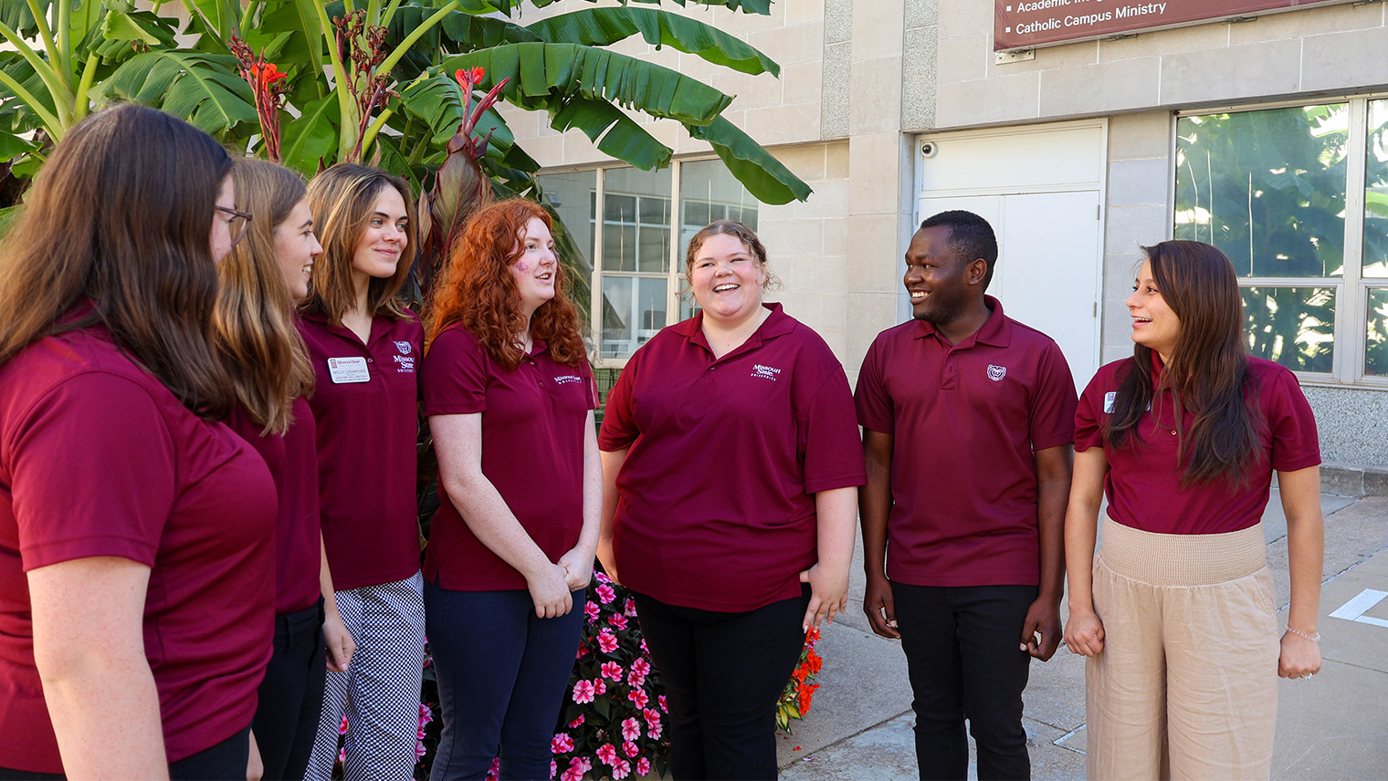 Graduate employees talking and smiling