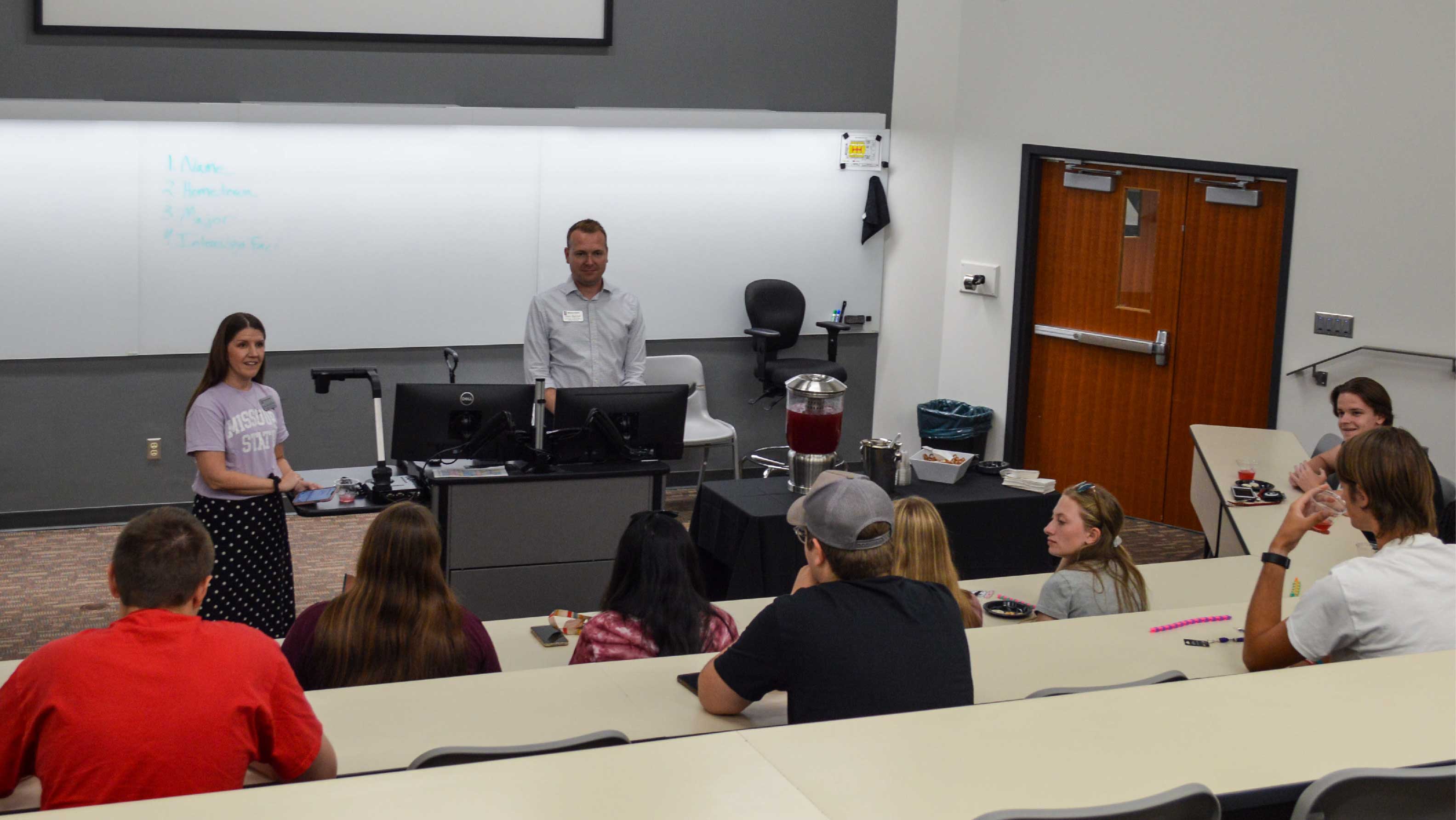 partners with students in lecture hall