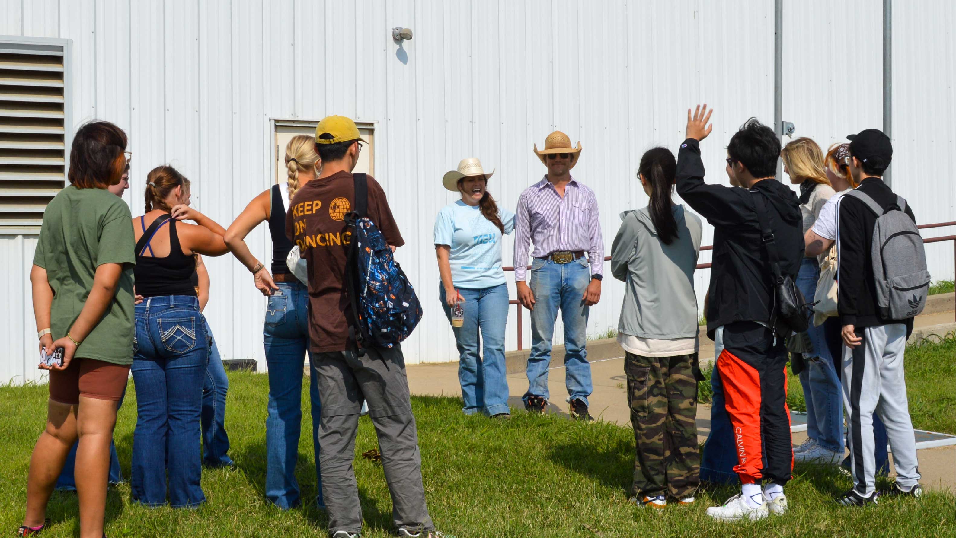 partners taking to group of students outside