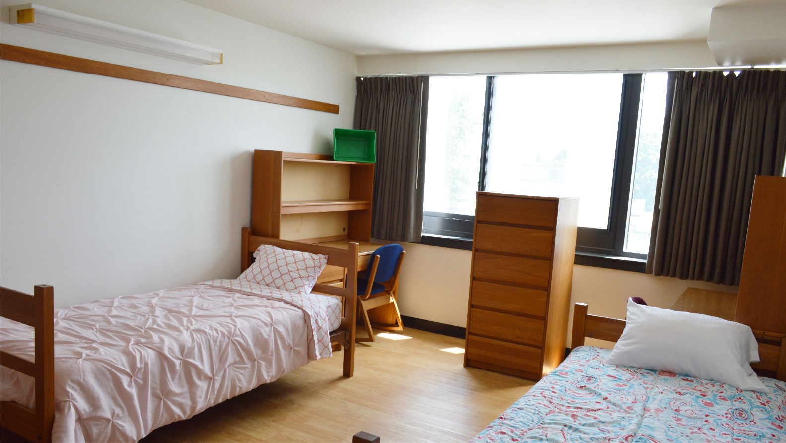 Hutchens bedroom with 2 beds a chest of 6 drawers and 2 desks with chairs
