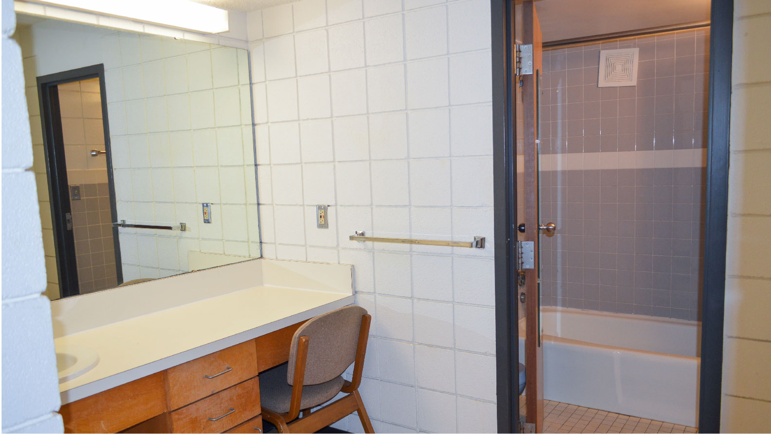 Hutchens 4-person suite vanity sink with large mirror and doorway to bathroom
