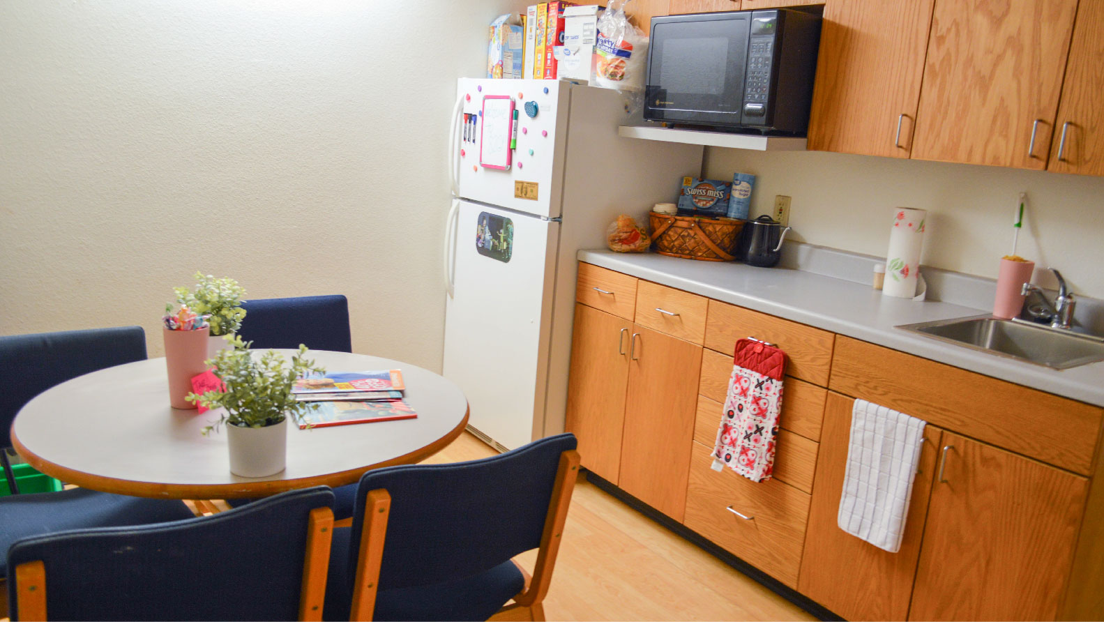 counter and cabinets with sink fridge and microwave