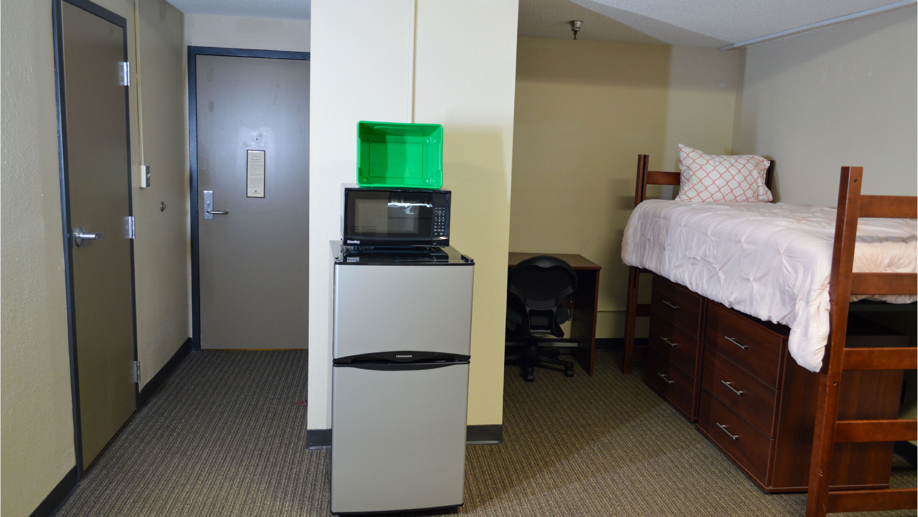 Bedroom with bed fridge and microwave desk and under-bed storage