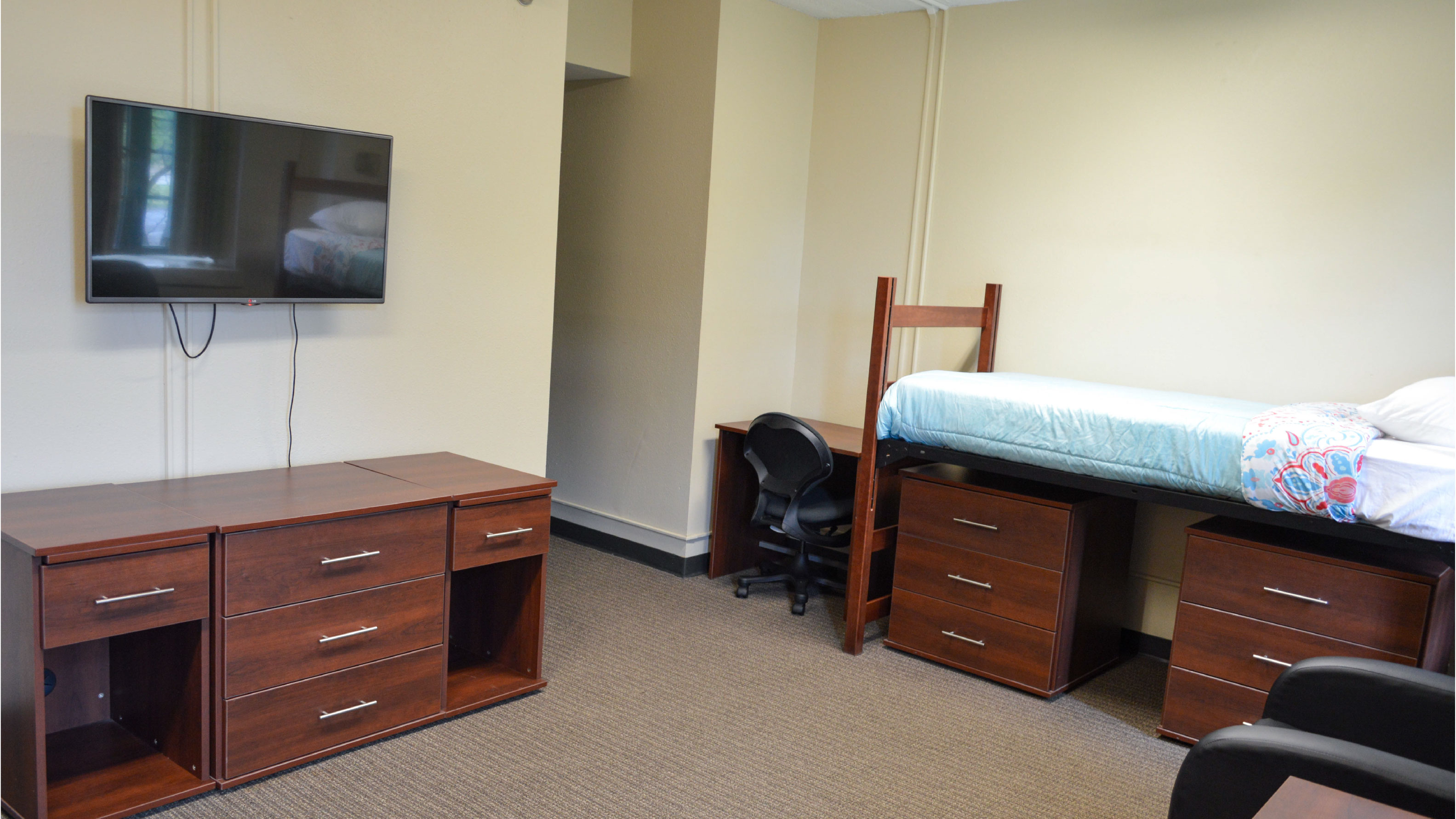 Bedroom with bed tv tv stand desk and under bed storage