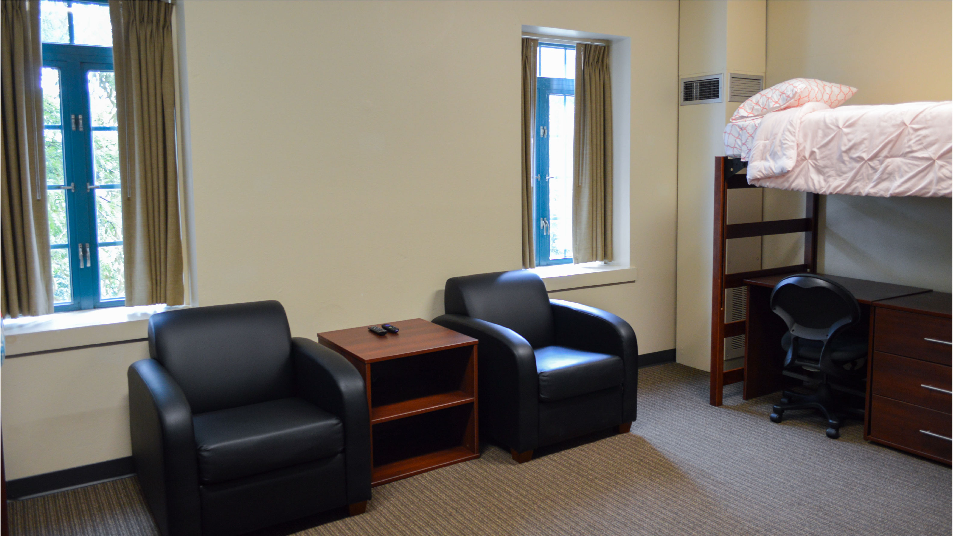 arm chairs with side table between and bed