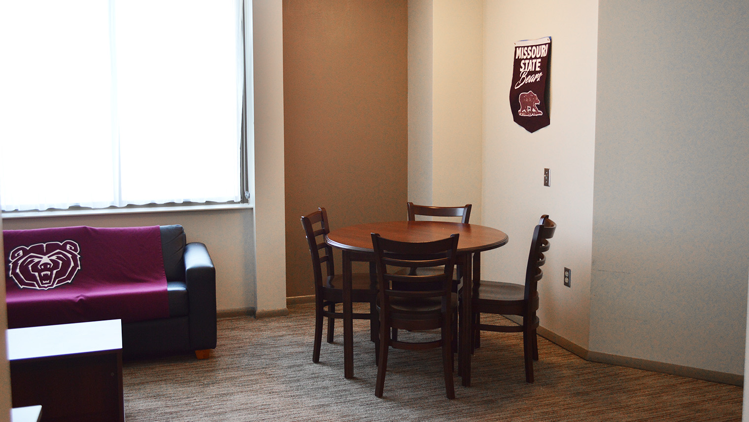 dining area with table and four chairs