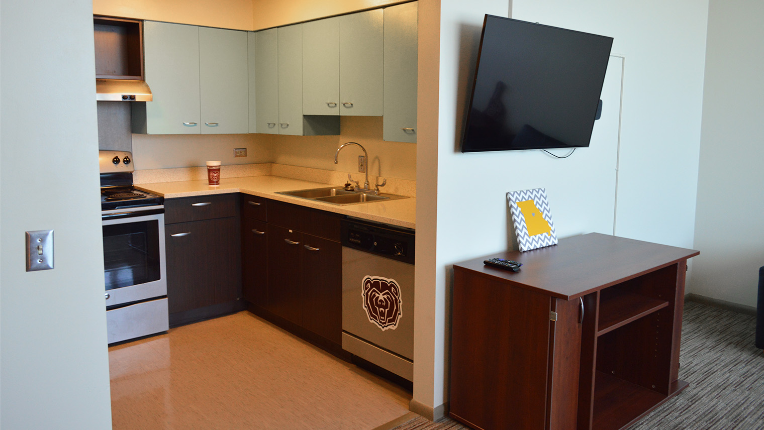 kitchen area with tv in living room