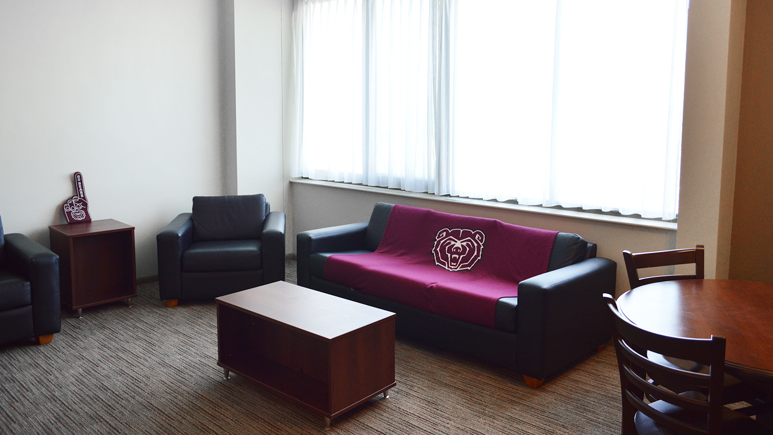 living room with large couch two chairs coffee table and in table