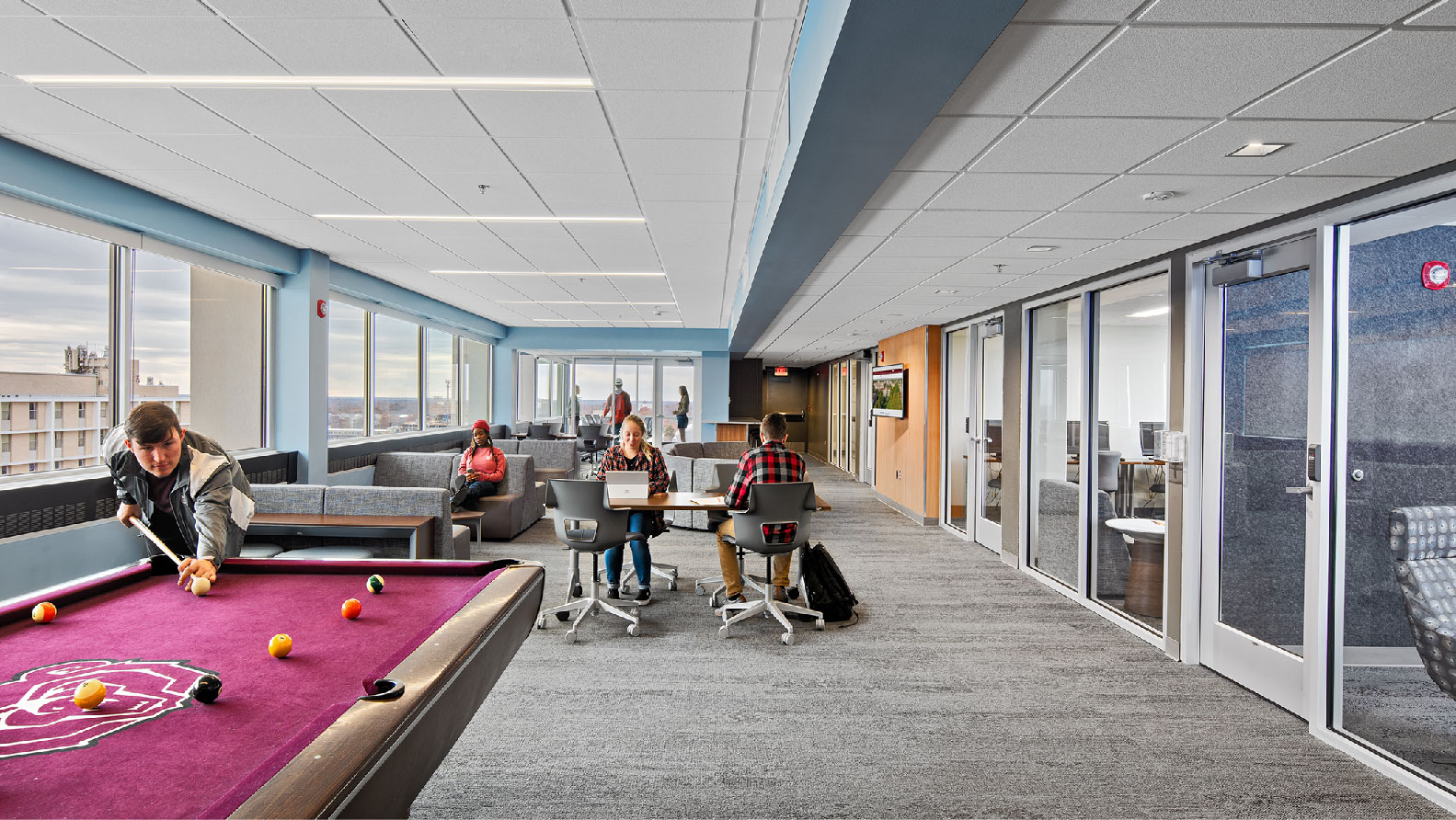 10th floor recreation longe with pool table desks couches and large windows