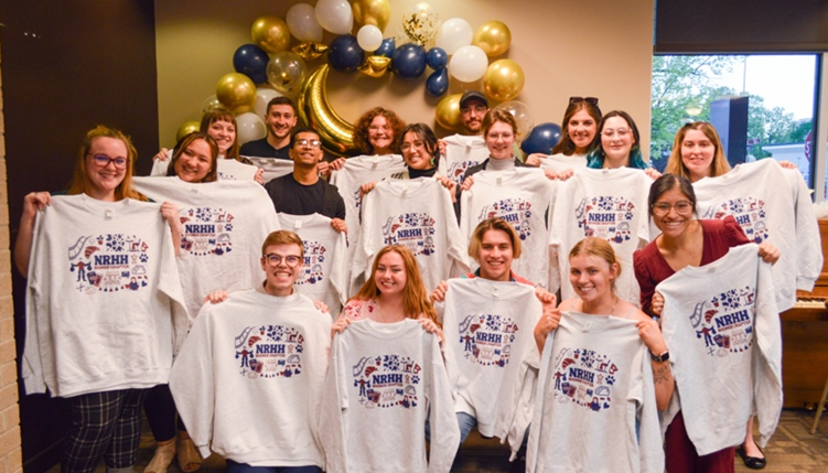 Group NRHH members pictured at their yearly banquet holding sweatshirts